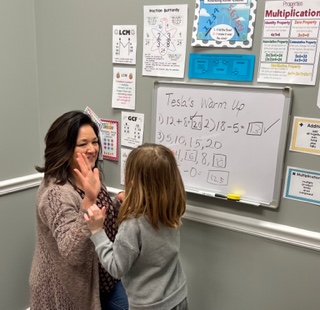 Tesla, grade 1, gives her tutor a Math Five!